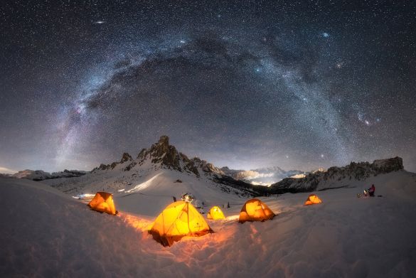 “Base Camp” – Giulio Cobianchi
 Dolomites – Italy 
I love shooting the Milky Way throughout all 12 months of the year. I must admit that during the winter season, it fascinates me even more, probably because the Milky Way has cooler colors that combine perfectly with the snow, and also because shooting under these conditions is much more challenging.
