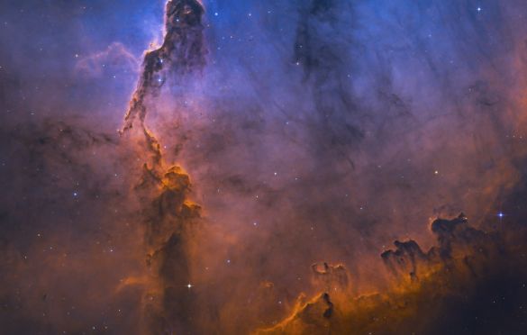 The Misty Elephant's Trunk © Min Xie (USA) - HIGHLY COMMENDED
The photographer imaged IC 1396, otherwise known as the Elephant’s Trunk, in the Hubble palette from my light-polluted backyard in Coppell, Texas. This image presents the Elephant’s Trunk surrounded by the emission clouds with a misty feeling and an emphasized blue doubly ionized oxygen area as the background. It really gives the feeling of the trunk emerging from the distance.
Takahashi FSQ-85 EDP telescope at f/5.35, Astrodon 3 nm filters, Astro-Physics Mach1GTO CP3 mount, ZWO ASI1600MM-Pro camera, RGB-Ha-SII-OIII composite, 46.6 hours total exposure